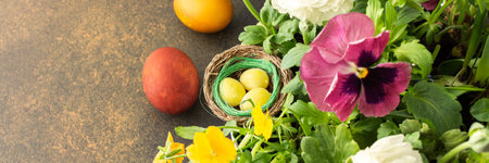 Top view of a vase with beautiful blooming flowers and Easter eggs, cute bunnies, copy space, Easter bannerの写真素材