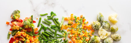 Frozen vegetable mix banner, frozen green beans and broccoli, corn and carrots, brussels sprouts and cauliflower, peas and bell peppers, copy space, top viewの写真素材