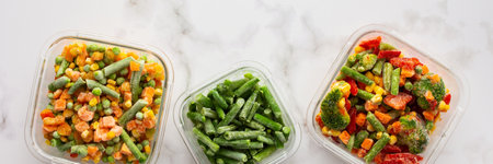 Frozen vegetables in containers banner , frozen cauliflower and asparagus beans, peas and corn, Brussels sprouts and carrots, mix of vegetables, top view, copy spaceの写真素材