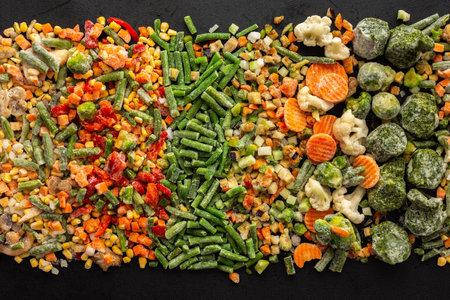 Frozen vegetable mix, frozen green beans and broccoli, corn and carrots, brussels sprouts and cauliflower, peas and bell peppers, eggplant and zucchini, top viewの写真素材