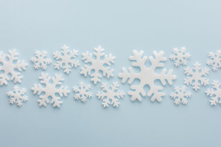 White snowflakes on a blue background, Christmas background, Merry Christmas and Happy New Year concept, top view, copy spaceの写真素材