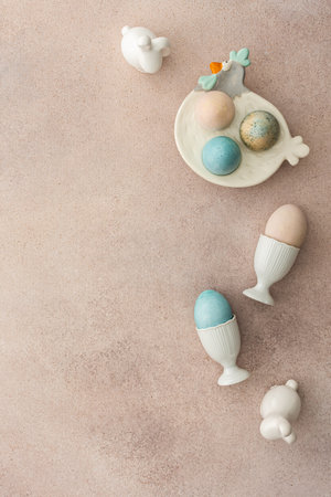 Colorful Easter eggs and cute bunnies on a pastel pink background, top view, copy spaceの写真素材