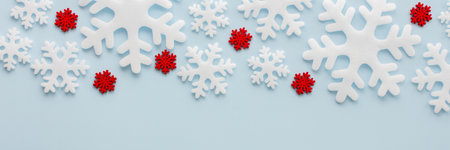White and red snowflakes on a blue background, Christmas banner, Merry Christmas and Happy New Year concept, top view, copy spaceの写真素材