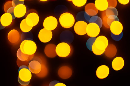 Christmas defocused lights, blurred colorful lights on a dark background, festive backgroundの写真素材