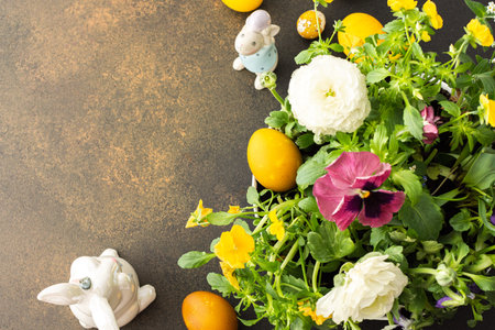 Top view of a vase with beautiful blooming flowers and Easter eggs, cute bunnies, copy space