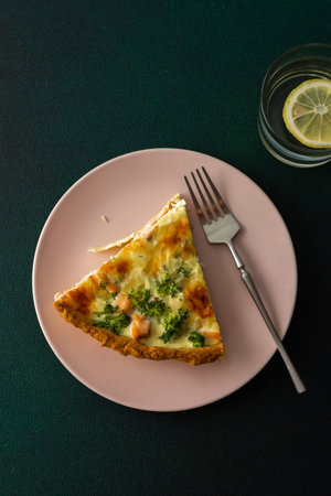 Homemade pie with red fish and broccoli, quiche with salmon and char, cheese and cream, portion of...