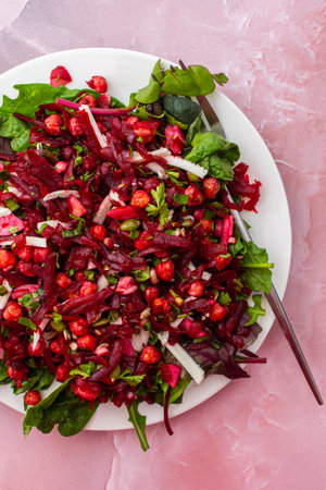 Healthy breakfasts or lunches, baked chickpeas and beetroot salad with goat cheese, mix of herbs and different seeds, top viewの写真素材