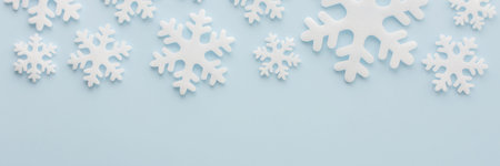 White snowflakes on a blue background, Christmas banner, Merry Christmas and Happy New Year concept,...