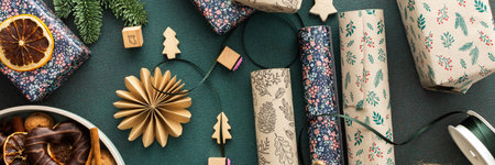 Preparing for the holiday, wrapping gifts under the Christmas tree in craft paper, Merry Christmas and New Year banner, plate with cookies and dry tangerine slicesの写真素材