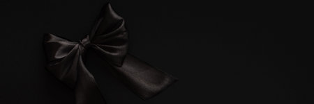Closeup black bow on a black background, black friday bannerの写真素材