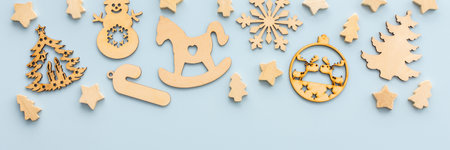 Natural wooden Christmas toys on a blue background, Merry Christmas and Happy New Year banner, top view, copy spaceの写真素材