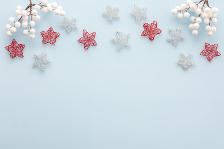 White and red stars and rowan branches on a blue background, Christmas background, Merry Christmas and Happy New Year concept, top view, copy spaceの写真素材