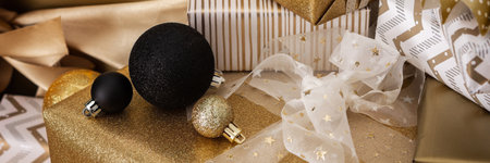 Preparations for the holiday banner, for dressing the Christmas tree, black and gold gifts and Christmas toys and decorations on the tableの写真素材