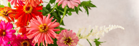 Summer bouquet of colorful Zinnia, onion inflorescences and mint sprigs, bouquet of flowers banner, home decoration with flowersの写真素材