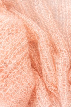 Home hobby, knitting a spider web sweater from pink threads, top view of the sweater and threadsの写真素材