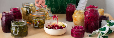 Fermenting different cabbages, white and red cabbage, Brussels and cauliflower, broccoli, woman...