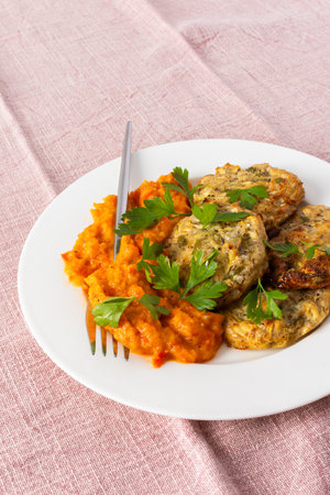 Enjoy a delicious vegetable breakfast with zucchini pancakes topped with fresh zucchini, tomato, and bell pepper caviar, offering a nutritious start to your dayの写真素材