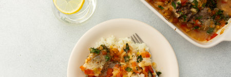White rice with baked vegetables and baked white pollock fish, a delicious hearty lunch or dinner, bannerの写真素材