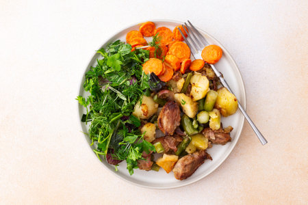 Stewed duck fillet with potatoes and asparagus and radishes, mixed salad of various greens, baked carrots in tahini sauce, healthy delicious breakfasts or lunchesの写真素材