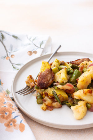 Stewed duck fillet with potatoes and asparagus and radishes, mixed salad of various greens, baked carrots in tahini sauce, healthy delicious breakfasts or lunchesの写真素材