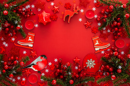 Red Christmas background with fir branches and red Christmas tree toys and balls and candlesの写真素材