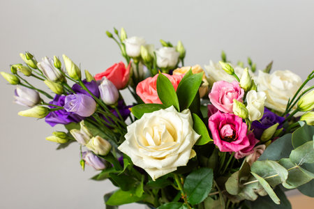 Celebrate special occasions with a colorful summer bouquet featuring fresh roses and eucalyptus, eustoma blooms, creating an elegant and fragrant floral arrangementの写真素材