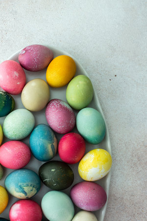 Multi-colored Easter eggs in an oval dish , top view, Happy Easter holidayの写真素材