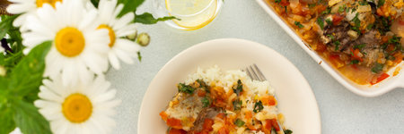White rice with baked vegetables and baked white pollock fish, a delicious hearty lunch or dinner, bannerの写真素材