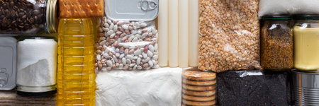 Home food supplies for quarantine and isolation, including canned food, cereals pasta and essential staples for survival, survival during military operations, the concept of stay at home, bannerの写真素材