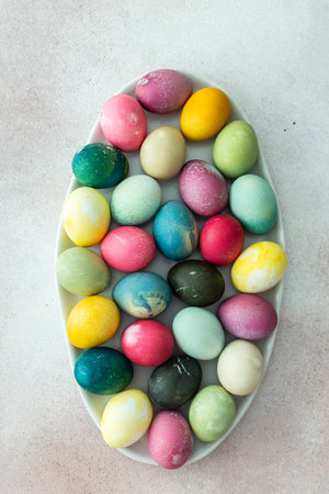 Multi-colored Easter eggs in an oval dish , top view, Happy Easter holidayの写真素材