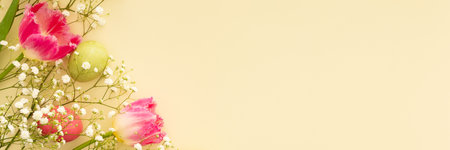 Spring Easter background, multi-colored Easter eggs with tulips and gypsophila on a yellow background, bannerの写真素材