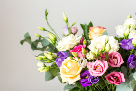 Celebrate special occasions with a colorful summer bouquet featuring fresh roses and eucalyptus, eustoma blooms, creating an elegant and fragrant floral arrangementの写真素材