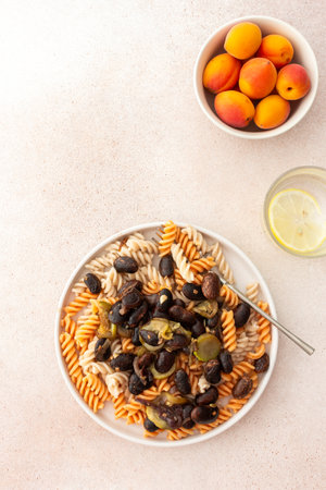 Enjoy gluten-free pasta paired with stewed beans and zucchini for a wholesome and tasty vegetarian dish that combines flavor with health benefitsの写真素材