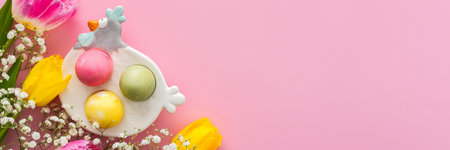 Spring Easter background, multi-colored Easter eggs and tulips with gypsophila on a pink background, copy space, bannerの写真素材
