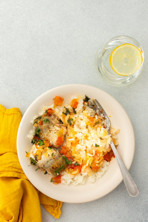 White rice with baked vegetables and baked white pollock fish, a delicious hearty lunch or dinnerの写真素材