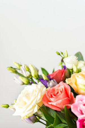A beautiful bouquet of vibrant roses, eucalyptus, and delicate eustoma in white, pink, and purple hues, perfect for an anniversary or birthday celebrationの写真素材
