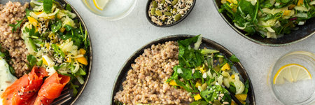 Delicious healthy breakfasts, green buckwheat with fried egg and spinach and red salmon fish, mix salad with fresh herbs and peppers and seeds, healthy balanced breakfast with fats, fiber and proteinの写真素材