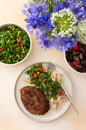 Enjoy a hearty meal with gluten-free pasta and a fresh salad of seasonal vegetables and herbs, complemented by ripe fruits for a balanced and nutritious breakfast or lunchの写真素材