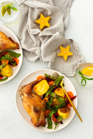 Enjoy a delicious, hearty meal with roasted potatoes and carrot salad, combining savory flavors and wholesome ingredients for a nutritious and satisfying dinnerの写真素材