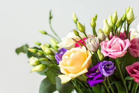 Celebrate special occasions with a colorful summer bouquet featuring fresh roses and eucalyptus, eustoma blooms, creating an elegant and fragrant floral arrangementの写真素材