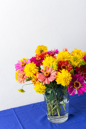 A summer bouquet featuring colorful Zinnia and Rudbeckia Goldquelle flowers adds vibrant beauty to home decoration, perfect for a seasonalの写真素材