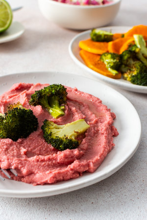 A nutritious morning meal featuring sweet potato, broccoli, radish salad with chia seeds and beet hummus for a balanced, protein-packed startの写真素材