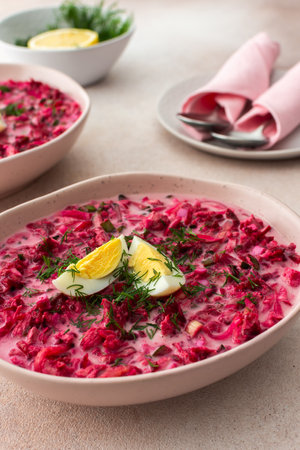 Summer cold beetroot soup made from beets, radishes, cucumbers, potatoes and herbs, garnished with egg, a refreshing summer lunchの写真素材