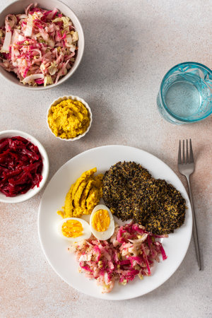 A nutritious breakfast featuring fresh cabbage, radish, mung bean sprouts, boiled eggs, hummus, and roasted beets, perfect for a balanced start to your dayの写真素材