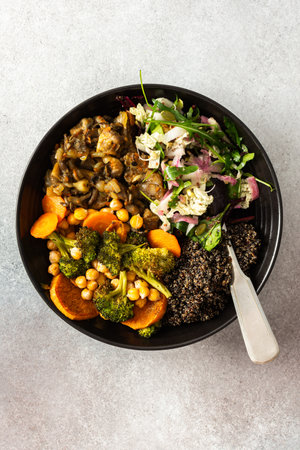 A filling, balanced breakfast with black quinoa, avocado, roast chicken, sweet potatoes, zucchini, broccoli, and a refreshing cabbage and radish salad with chia and sesame seedsの写真素材