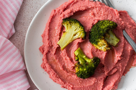A balanced breakfast with beetroot hummus and broccoli offering a wholesome start to the dayの写真素材