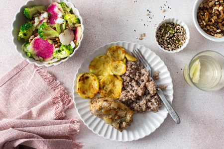 Green buckwheat paired with fried hake, zucchini, and a colorful salad of broccoli, pink radish, and seeds, providing a protein-packed, healthy breakfast to fuel your morningの写真素材
