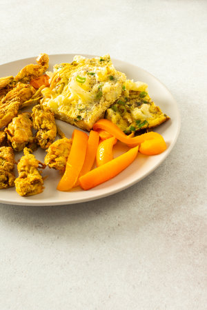 Enjoy a delicious vegetarian meal with fried zucchini flowers in batter, a cauliflower omelette with stewed peppersの写真素材
