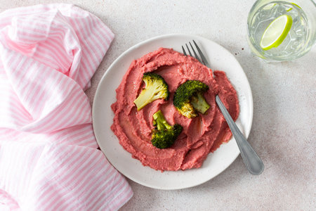A balanced breakfast with beetroot hummus and broccoli offering a wholesome start to the dayの写真素材
