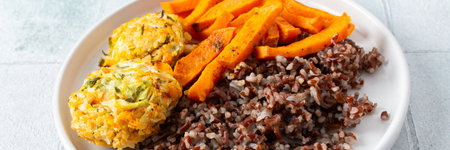 Brown rice paired with baked sweet potatoes and squash chickpea pancakes creates a hearty, healthy and flavorful dish thats both filling and nutritious, bannerの写真素材